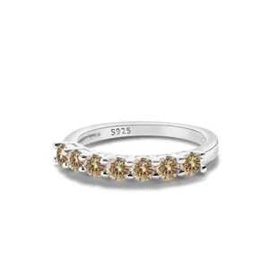 Detail showing S925 hallmark on silver band with seven champagne round-cut gemstones
