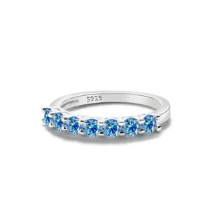 925 sterling silver ring featuring seven round blue moissanite stones on a white background