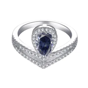 Detail of pear-cut blue gemstone ring with sparkling pavé setting and silver finish