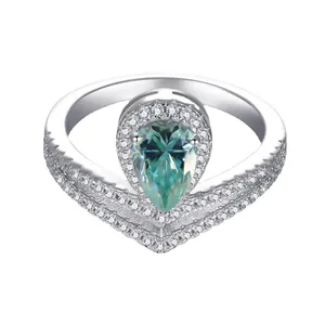 Elegant sterling silver ring featuring a pear-cut blue moissanite and crown halo setting