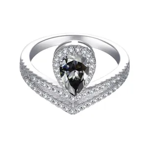 Silver crown ring with pear-cut gray moissanite and pave stones on white background