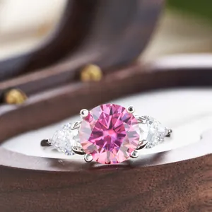 Macro shot of s925 silver ring featuring a 3ct pink moissanite with pear side stones