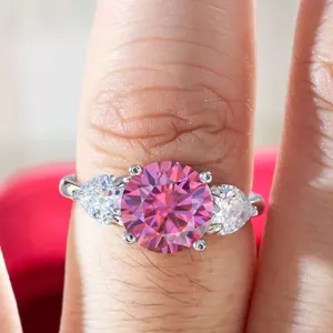 Detailed view of s925 silver ring featuring a 3-carat pink round-cut center stone on finger