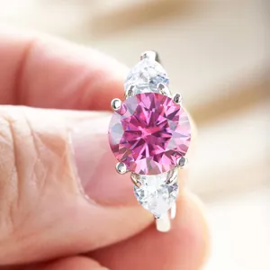 Detail of s925 silver ring featuring a 3-carat pink round stone and side pear diamonds