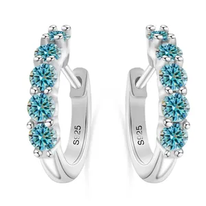 Close-up of S925 sterling silver earrings featuring five round blue moissanite stones