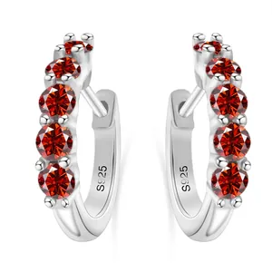 Close-up of S925 sterling silver earrings featuring five round red moissanite stones
