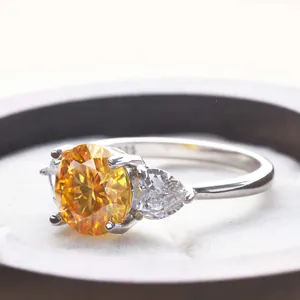 Macro detail of s925 silver ring with 3ct yellow center stone and side pear diamonds