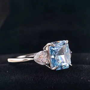 Macro view of a 3ct radiant cut light blue diamond ring with side pear-shaped accents
