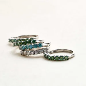 Macro detail of five S925 sterling silver rings with colorful round-cut gemstones
