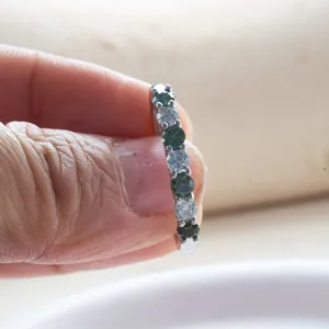 Eternity ring in sterling silver featuring alternating blue and white moissanite stones