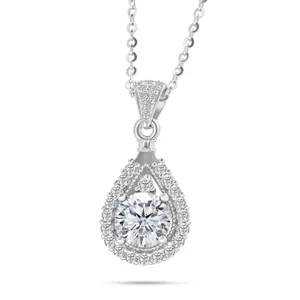 Macro shot of silver teardrop pendant necklace featuring halo-set moissanite stone