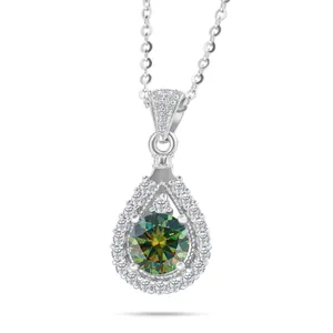 Macro detail of teardrop halo pendant with sparkling round cut green moissanite stone