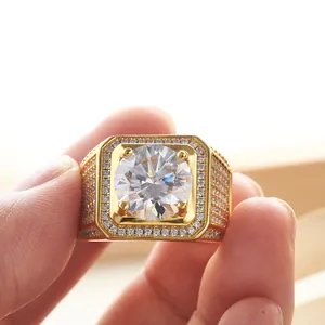 Close-up of a luxury men's ring with a large center stone and pavé-set diamonds