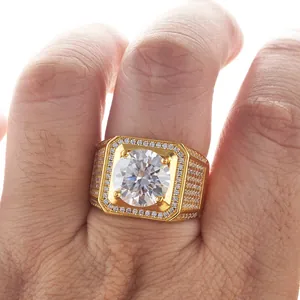 Macro view of luxury gold-plated men's ring with large moissanite center stone and pavé accents