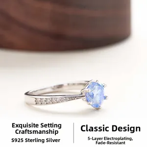 Macro shot of 925 sterling silver ring featuring a six-prong light blue moissanite stone