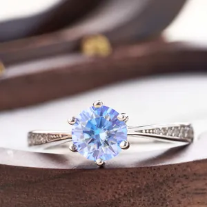 Macro shot of 925 silver ring featuring blue moissanite in a six-prong setting detail