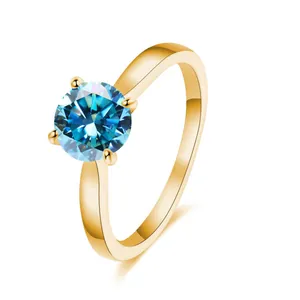 Minimalist 2ct blue moissanite ring with gold 4-prong setting on a polished silver band
