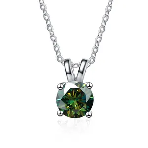 Macro shot of green round cut moissanite pendant with classic four-prong silver setting
