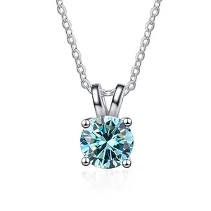 Detailed close-up of a blue moissanite stone in a four-claw silver pendant setting