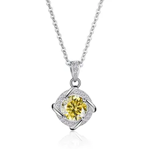 Detail of sterling silver necklace with a round yellow moissanite pendant and halo diamonds