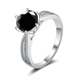 Detail of S925 silver ring featuring a six-prong set round black gemstone with side diamonds