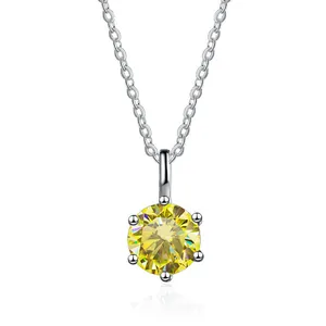 Macro shot of yellow round cut moissanite pendant with classic six-prong silver setting