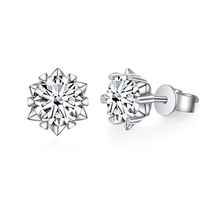 Macro detail of snowflake stud earrings featuring heart-shaped prongs and moissanite stone