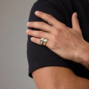 Close-up of a man wearing a gold and silver Tai Chi Yin Yang ring made of stainless steel