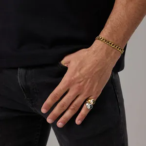 Close-up of men wearing gold and silver Tai Chi Yin Yang rings with a Cuban link bracelet