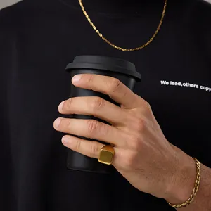 Close-up of minimalist 18K gold plated square signet ring and chain jewelry set for men