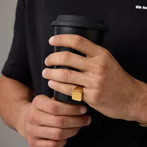 Polished 18K gold-plated stainless steel square signet ring shown in lifestyle setting