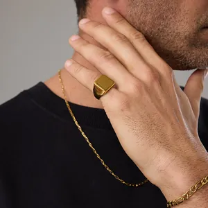 Macro view of men's square 18K gold plated signet ring with smooth polished finish