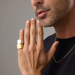 Polished 18K gold and silver square signet rings with a matching thin gold necklace