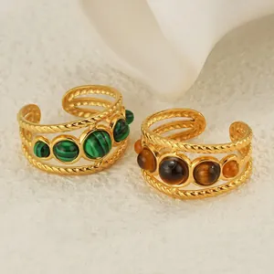 Dettaglio di anelli vintage placcati oro 18K con perline di pietra verdi e marroni