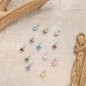 Macro view of assorted colorful star-shaped charms with polished silver finish and gemstones