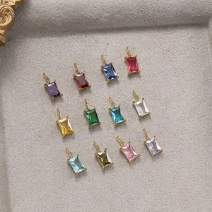 Macro shot of twelve rectangular colorful gemstones with gold plating on a jewelry tray