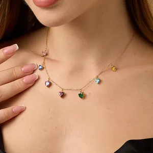 Close-up of a gold 18K necklace featuring seven colorful heart-shaped zircon gemstones