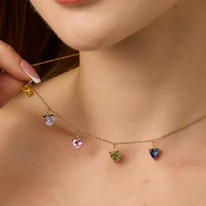 Macro view of 18K gold chain necklace with five colorful heart-shaped zircon pendants