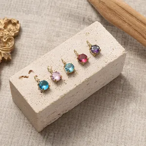 Set of five colorful round gem pendants with vintage gold four-prong settings