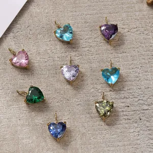 Macro shot of colorful heart-shaped zircon pendants with 18K gold-plated claw settings