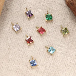 Minimalist square zircon pendants in eight colors with golden claw settings on fabric