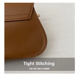 Close-up of tight stitching and gold metal buckle on a brown leather handbag detail