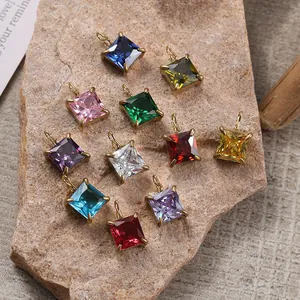 Macro shot of colorful square-cut gemstone pendants with gold four-prong settings