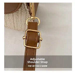 Detail of adjustable leather shoulder strap with gold buckle on woven straw bag