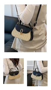 Detail of summer straw crossbody bag with black leather flap and golden U-shaped buckle
