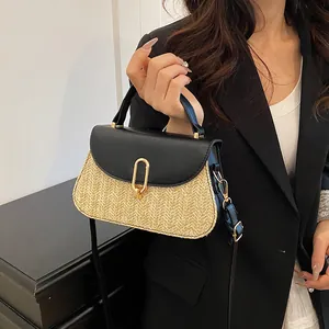 Straw patchwork handbag with black leather flap and golden U-shaped buckle closure
