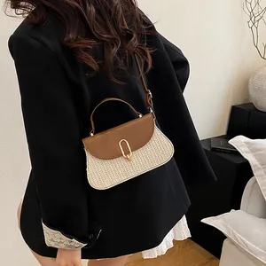 Minimalist straw woven crossbody bag with brown leather flap and golden oval metal buckle
