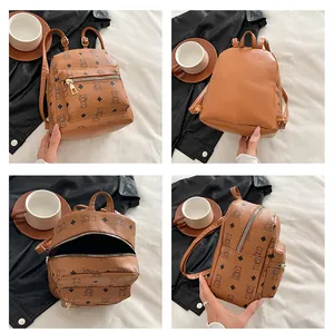 Detail view of mini PU leather backpack featuring brown teddy bear print and adjustable straps