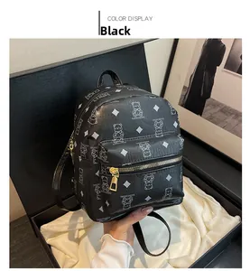 Detailed macro view of black PU leather backpack with bear print on silk gift lining