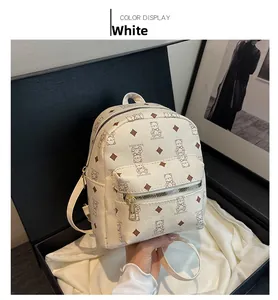 Detail of white mini backpack with bear print on silk cloth inside a gift box